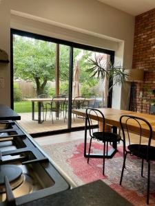 a kitchen with a table and chairs and a patio at La Grange des Duc(s) in Eckbolsheim