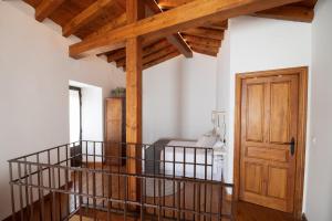 a room with a staircase and a wooden door at El Postigo in Trujillo