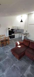 uma sala de estar com um sofá e uma cozinha em Maison de village avec une pièce de vie lumineuse em Saint-Paul-de-Fenouillet