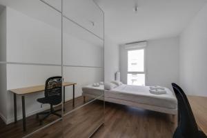 una camera da letto con un letto, una scrivania e un tavolo di Élégance en Banlieue Parisienne a Noisy-le-Sec