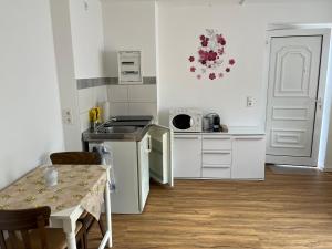 a small kitchen with a table and a counter top at Turmwohnung in Kreischa