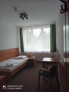 a hotel room with a bed and a window at HOTEL ODR in Sulechów +60 photos