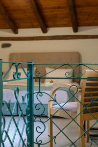 a bedroom with a bed with a green iron gate at PRINOS GARDEN in Farsáron
