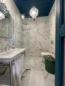 a bathroom with a sink and a shower at Riad Tibibt in Marrakesh