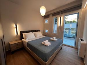 a bedroom with a bed with two towels on it at Elia Luxury Residence in Chalkida