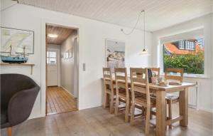 a kitchen and dining room with a table and chairs at Beautiful Home In Skagen With Wifi in Skagen