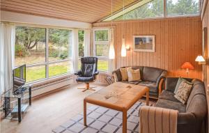 a living room with a couch and a table at Amazing Home In Lkken With 3 Bedrooms And Sauna in Grønhøj