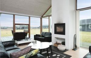 a living room with a couch and a tv at 4 Bedroom Pet Friendly Home In Lkken in Løkken