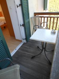 a white table and chairs on a balcony at Ottenkellerhof in Bolzano +24 photos
