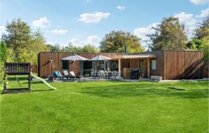 a small house with a lawn in front of it at Beautiful Home In Sjællands Odde in Yderby
