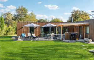 a backyard with a house with a green lawn at Beautiful Home In Sjællands Odde in Yderby +27 photos