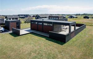 a modern house on a field of grass at Three-Bedroom Holiday Home In Lokken in Løkken