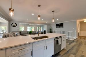a kitchen with a sink and a couch at Spacious Lake Norman Retreat with Private Dock! in Sherrills Ford