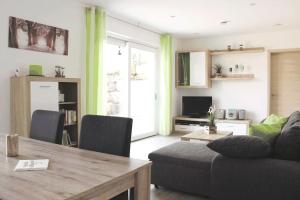 a living room with a couch and a dining room table at Wunderwelt Betzenstein familiär-ländlich-modern in Betzenstein