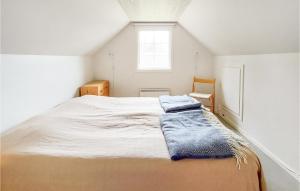 a bedroom with a bed with two towels on it at Stunning Home In Vittsj With 3 Bedrooms in Vittsjö