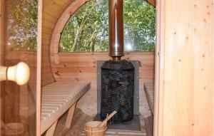 a sauna with a wood stove in a cabin at 2 Bedroom Nice Home In Wejdyki in Wejdyki +14 photos