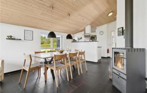 a kitchen and dining room with a table and chairs at Cozy Home In Hemmet With Sauna in Hemmet
