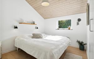 a bedroom with a bed with a wooden ceiling at Cozy Home In Hemmet With Sauna in Hemmet +17 photos