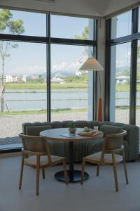 a living room with a couch and a table and chairs at Golden Harvest Homestay in Toucheng