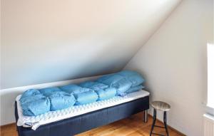 a bed in a room with blue pillows on it at Matildes Hus in Skagen