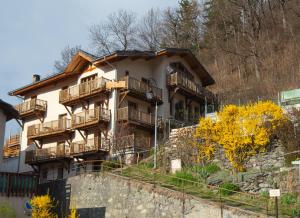 a building on a hill with balconies on it at Maison Caramel Chalet in Landry