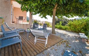 a group of chairs sitting on a deck under a tree at Nice Home In Casalabriva With 2 Bedrooms And Wifi in Casalabriva