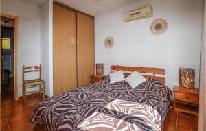 a bedroom with a bed and a chair at Nice Home In Casalabriva With Wifi in Casalabriva