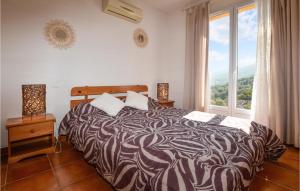 a bedroom with a bed and a large window at Nice Home In Casalabriva With Wifi in Casalabriva