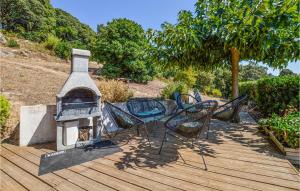 a group of chairs and a fireplace on a wooden deck at Nice Home In Casalabriva With Wifi in Casalabriva