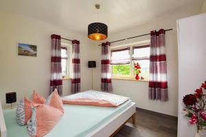 a bedroom with a bed and a window at Ferienhaus Lina in Siegmundsburg