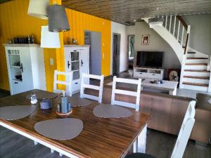 a dining room with a wooden table and chairs at Ferienhaus Lina in Siegmundsburg