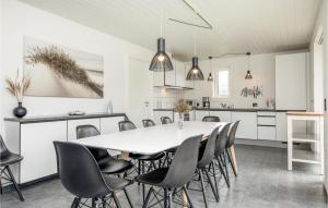 a kitchen and dining room with a table and chairs at Beautiful Home In Blokhus With Sauna, Wifi And Indoor Swimming Pool in Blokhus
