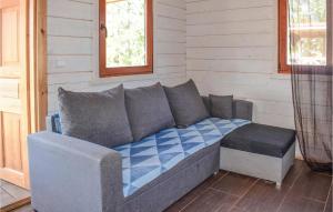 a couch sitting in the corner of a room at Awesome Home In Wejdyki With Sauna in Wejdyki