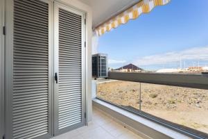 a door to a balcony with a view of the desert at El Medano in El Médano