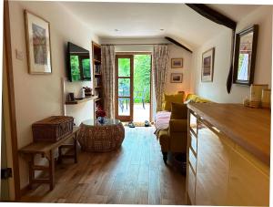 a living room with a couch and a table at Thatchcombe B&B in Wantage