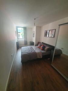 a bedroom with a bed and a large mirror at Double Room with Shared Bathroom in London