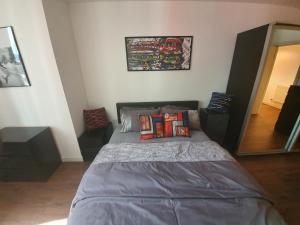 a bedroom with a bed with pillows on it at Double Room with Shared Bathroom in London