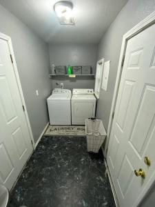 a laundry room with a washer and dryer at Xscapecation Oasis in Tulsa
