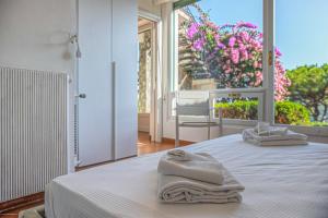 a bedroom with a bed with two towels on it at Villa Orchidea by PortofinoHomes in Santa Margherita Ligure