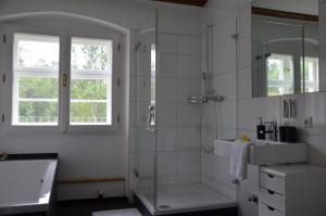 a white bathroom with a shower and a sink at Goldschmiedsmühle in Lindau +53 photos
