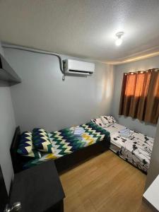a small room with a bed and a window at One Oasis Condominium 2 Bedroom in Davao City