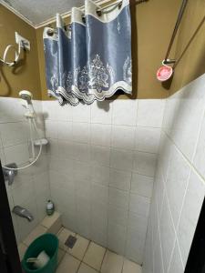 a bathroom with a toilet and a shower curtain at One Oasis Condominium 2 Bedroom in Davao City