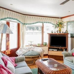 a living room with a couch and a tv at Stunning 7 Bedroom Bungalow Alford Aberdeenshire in Alford