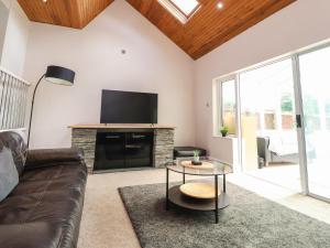 a living room with a couch and a flat screen tv at Palm Court in Carnforth