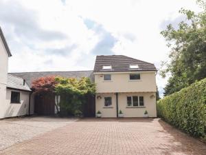 a white house with a brick driveway at Palm Court in Carnforth