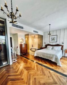 a bedroom with a bed and a wooden floor at ANDRO LUX 2BR apartment with pool in Old Jaffa in Tel Aviv