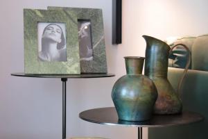 two vases sitting on a table next to a couch at DOURO VIEWS Luxury Design Beach Apartment in Vila Nova de Gaia
