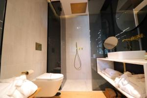 a bathroom with a toilet and a sink and a shower at DOURO VIEWS Luxury Design Beach Apartment in Vila Nova de Gaia +57 photos