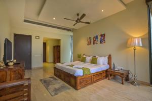 a bedroom with a bed and a television in it at Misty Villa by Tropicana Stays in Lonavala +19 photos