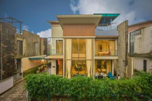 a house with a view of the front of it at Misty Villa by Tropicana Stays in Lonavala